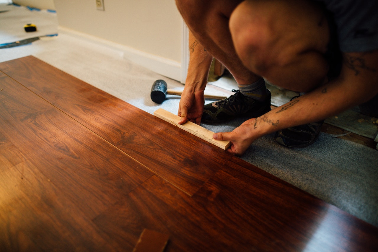 person laying laminate floor